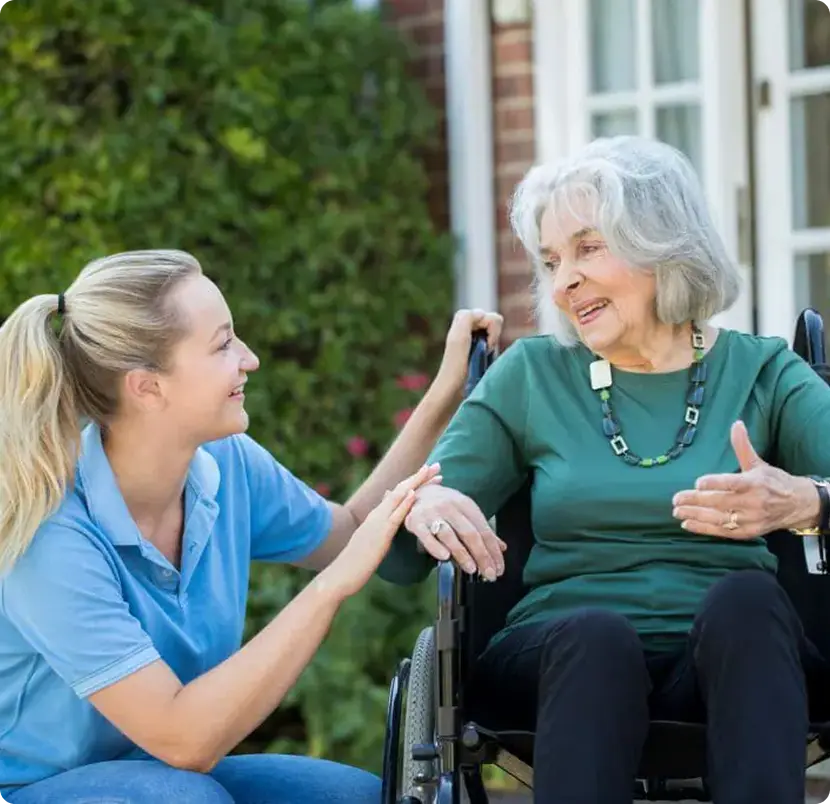 A woman in a wheelchair speaks with an older woman