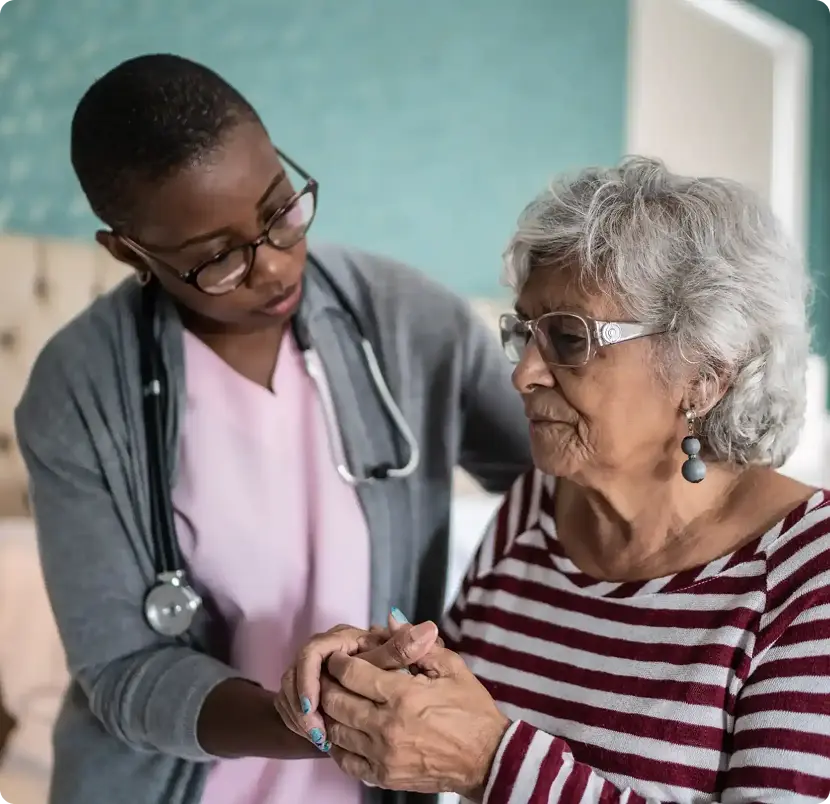 A nurse is helping an elderly woman with her wrist