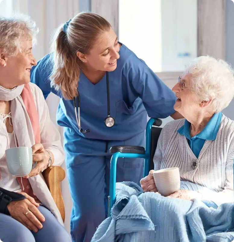 A nurse speaks with an elderly woman in a wheelchair
