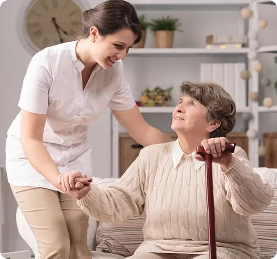 A younger woman helps an elderly woman with a walker