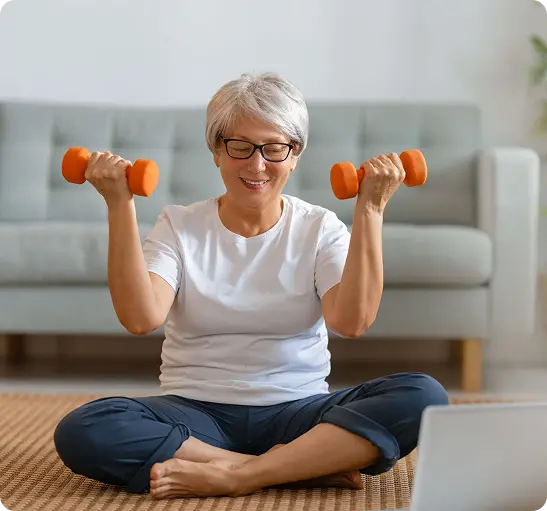 An older woman sits on the floor