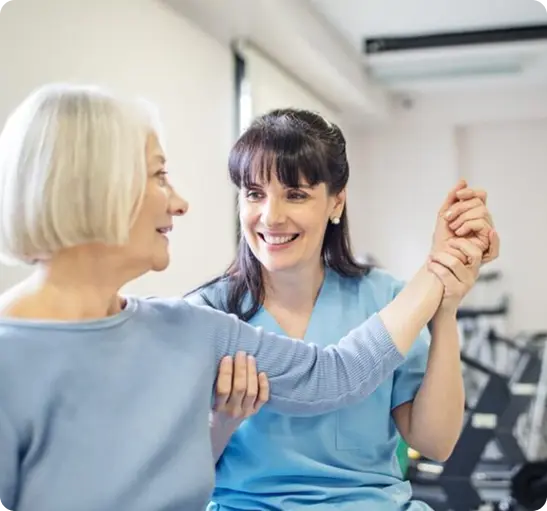 A woman dances joyfully with an older woman