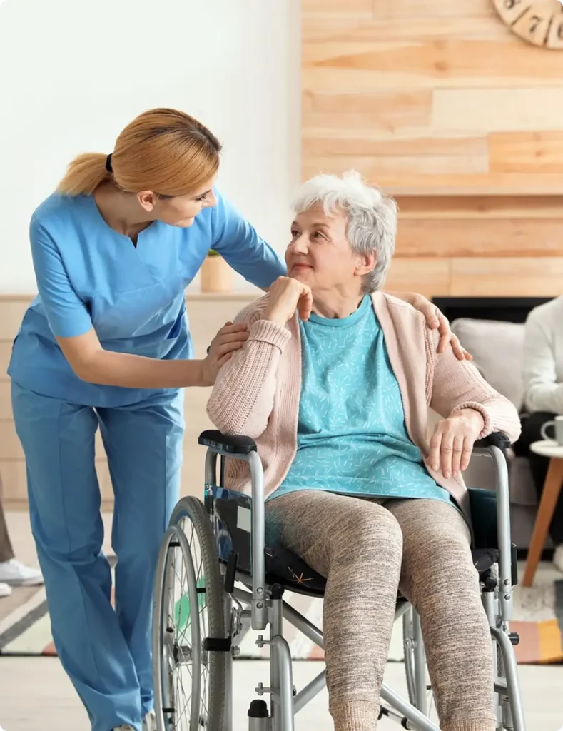 A nurse helps a woman in a wheelchair